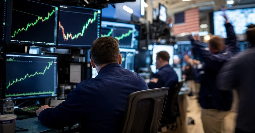 Trading floor with screens showing rising stock charts during a record market rally.