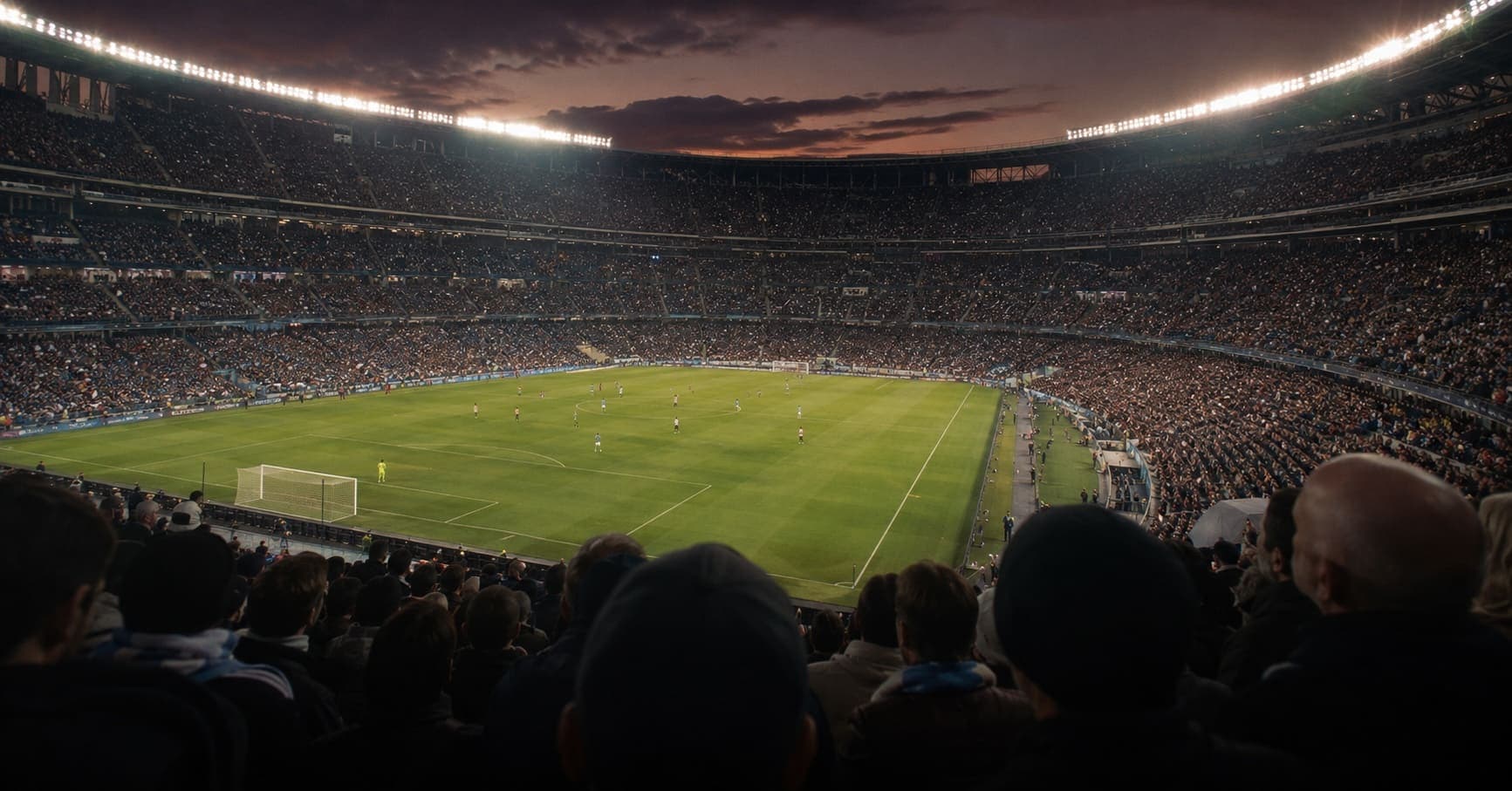 Packed professional soccer stadium under floodlights during an evening match