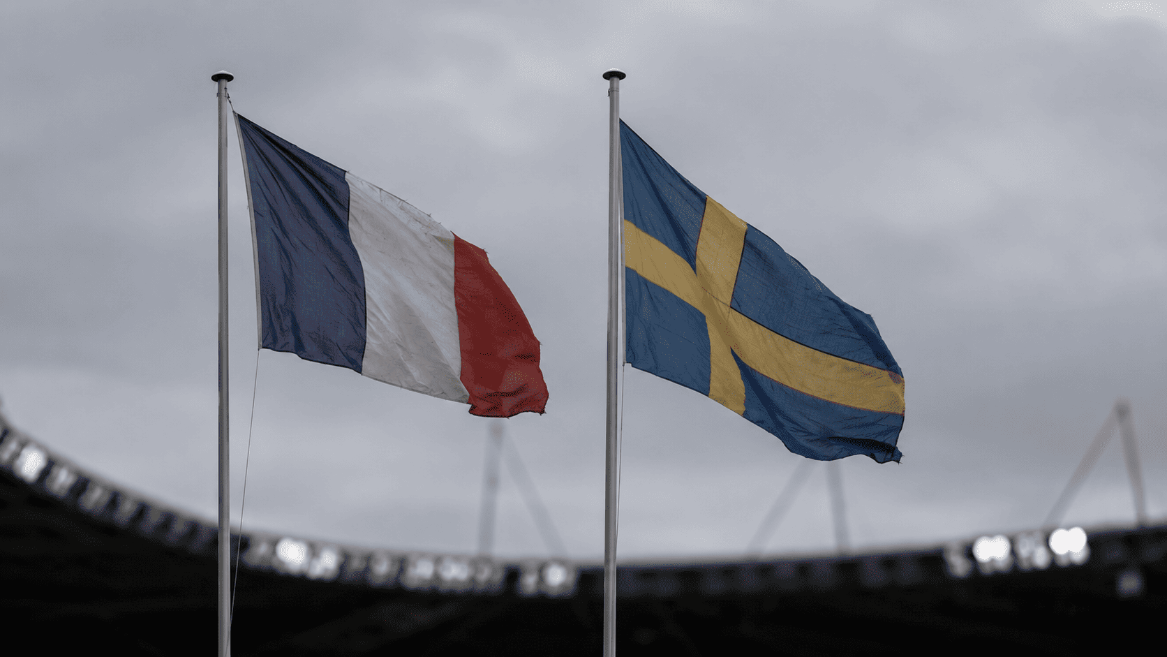 The flags of France and Sweden flying side by side outside a stadium ahead of their World Cup match.