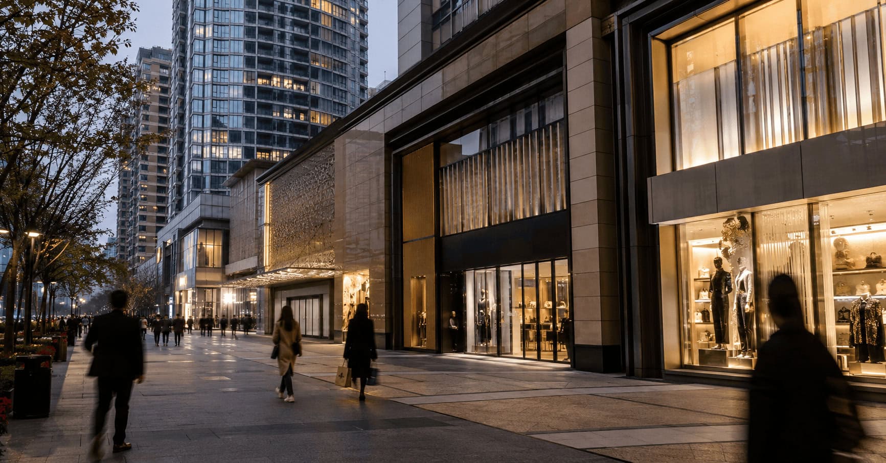Upscale shopping and high-rise district in an East Asian city at dusk with luxury storefronts and apartment towers.