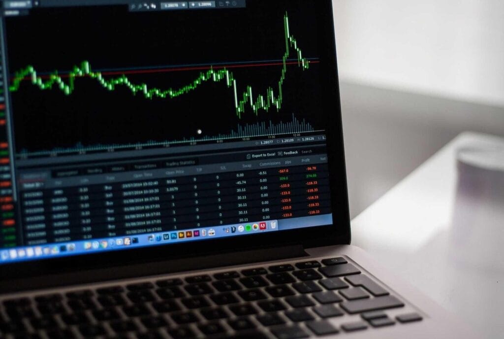 Financial trading chart showing stock market fluctuations on a laptop screen.