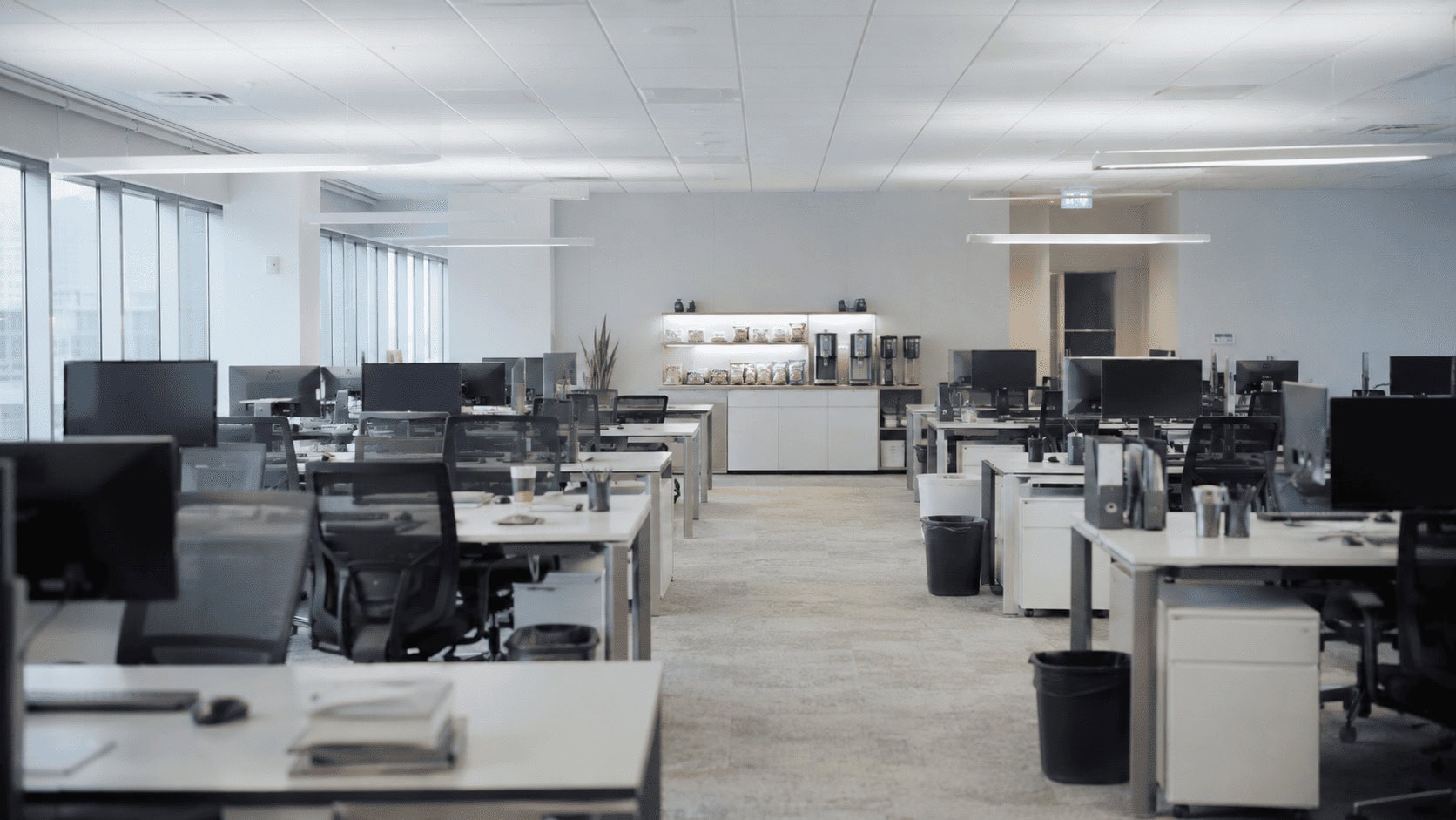 Empty Meta office at dusk with an under-stocked snack station, illustrating the company's AI reorg and morale crisis