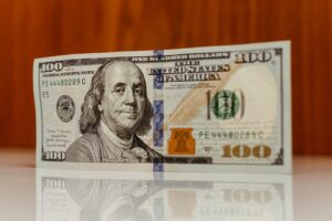 Close-up of a hundred-dollar bill with Benjamin Franklin's portrait.