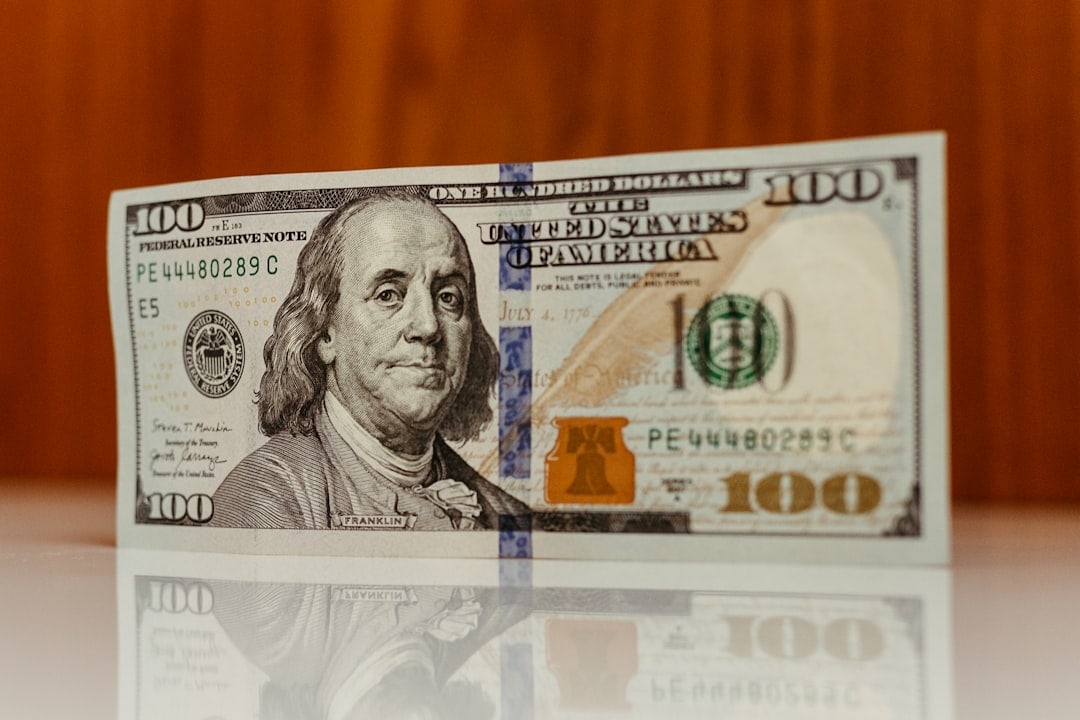 Close-up of a hundred-dollar bill with Benjamin Franklin's portrait.