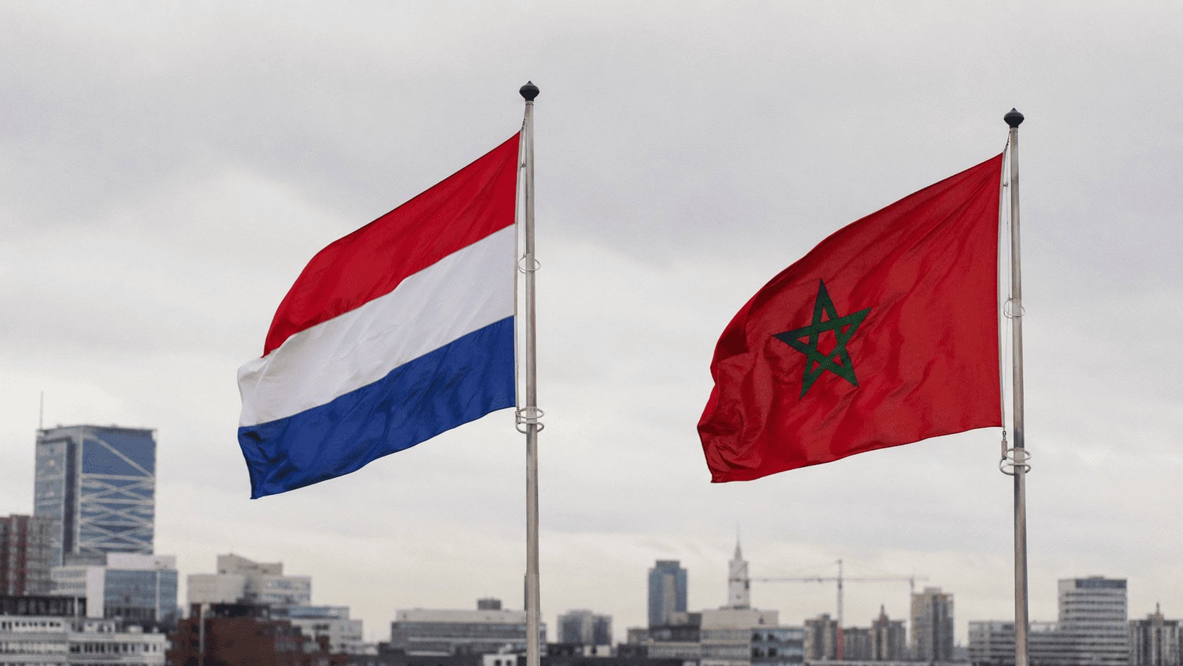 The flags of the Netherlands and Morocco displayed side by side, representing a comparison of the two economies.