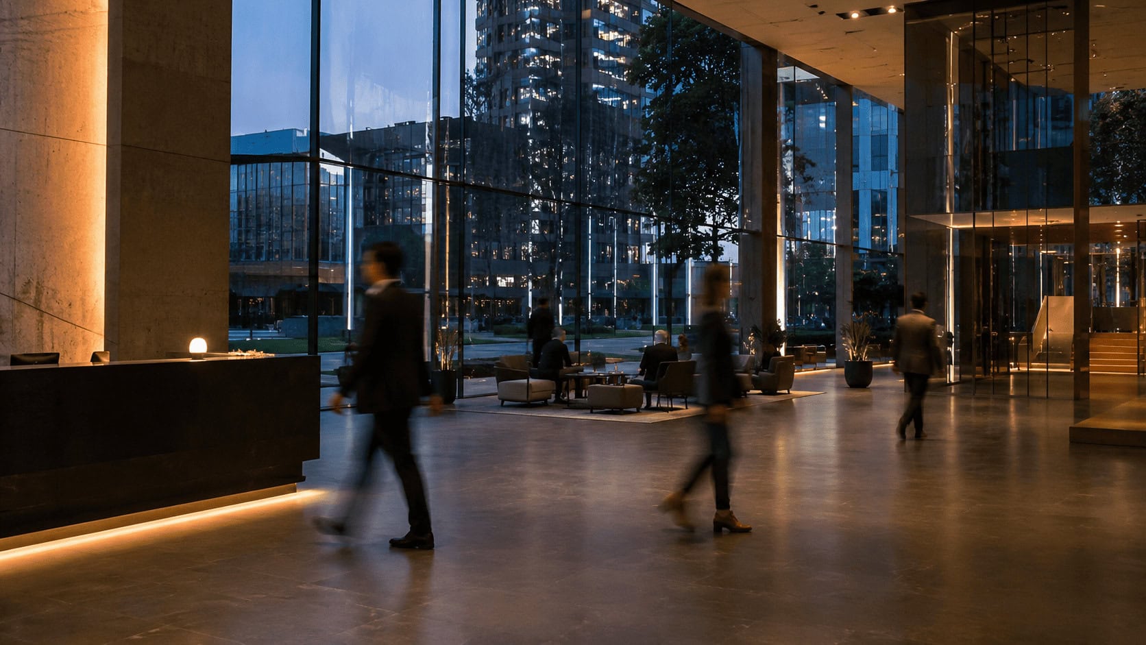Glass-fronted technology company headquarters lobby at dusk with blurred figures walking through the entrance.