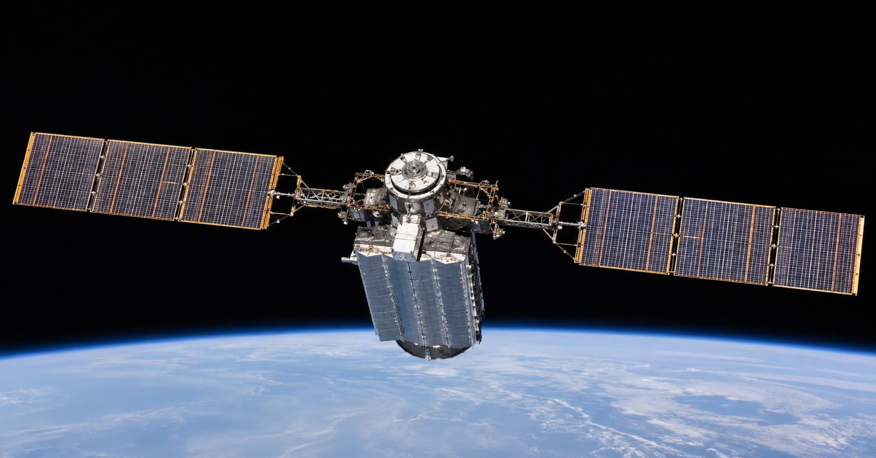 Solar-powered data center satellite in low Earth orbit with Earth visible below, illustrating orbital AI compute infrastructure
