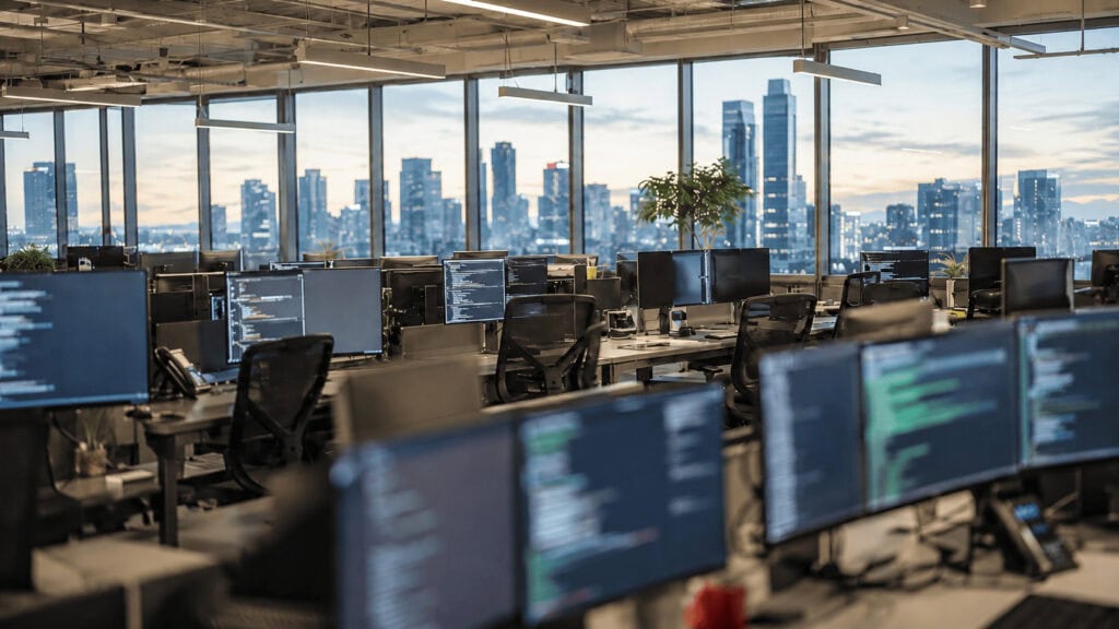 Empty software engineering office at dusk representing the SpaceX acquisition of AI coding startup Cursor
