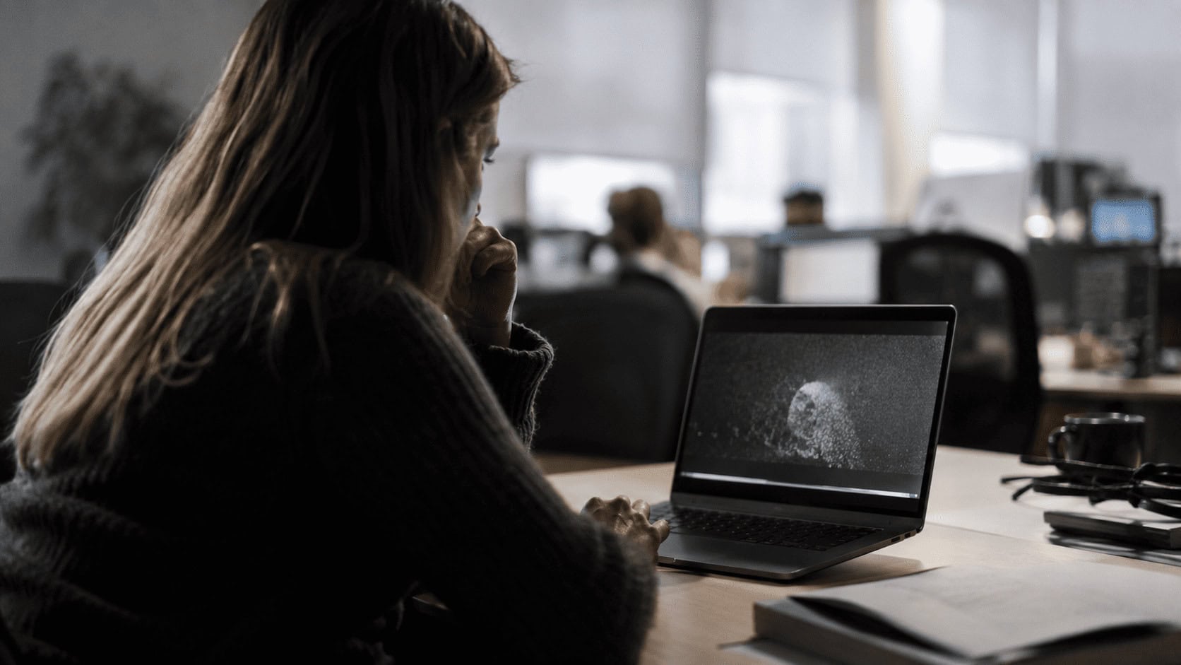 A user watching an AI browser agent complete a task on a laptop screen