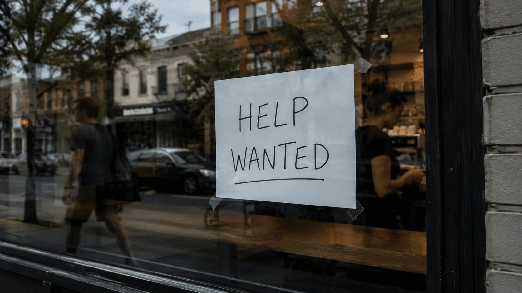 Help Wanted sign in a Canadian restaurant window during summer 2026, reflecting the part-time and food-service hiring behind June's jobs report