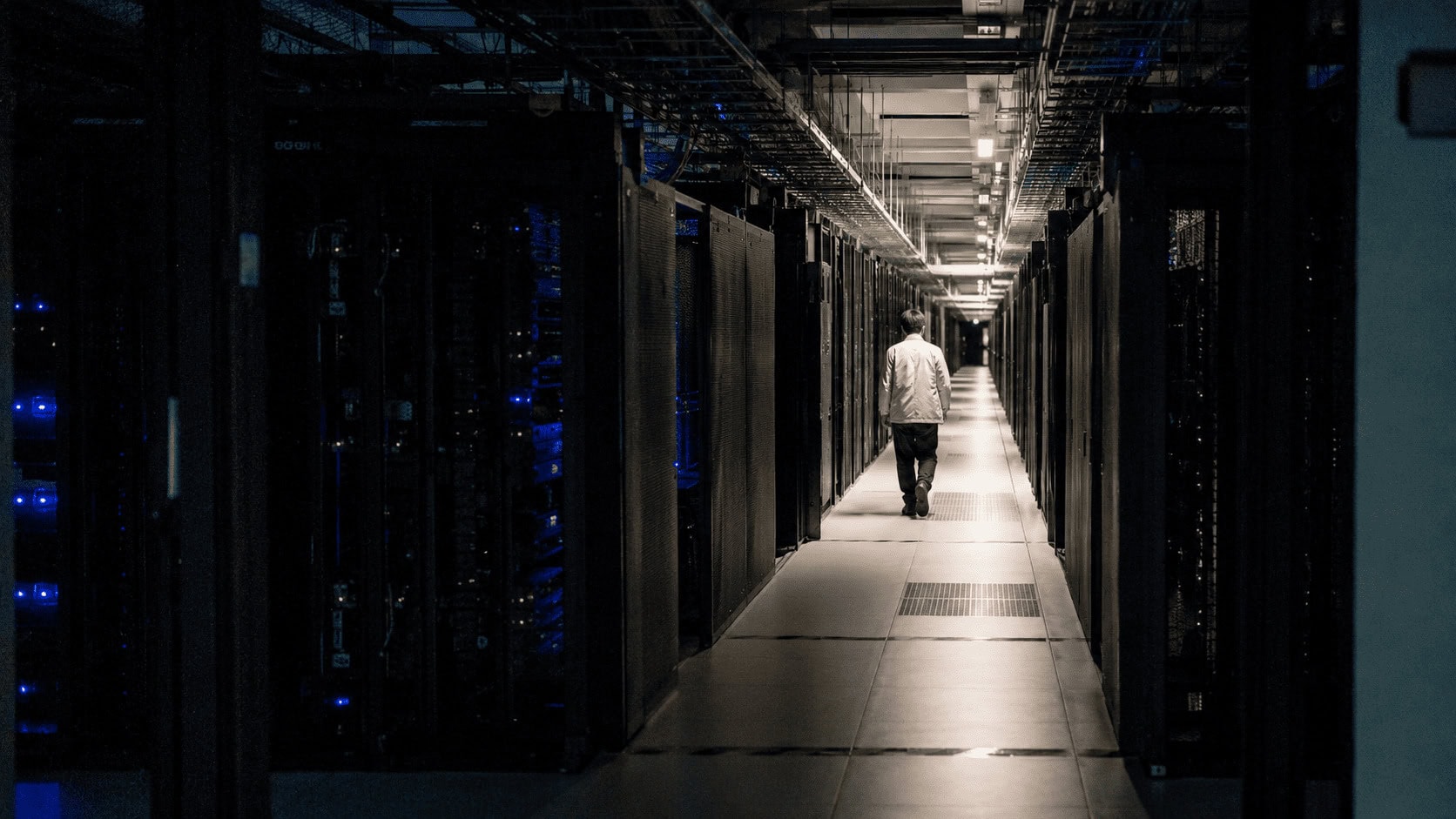 Rows of servers in a Chinese data center with only one aisle powered, illustrating the compute capacity limits behind Moonshot's Kimi K3 subscription pause.