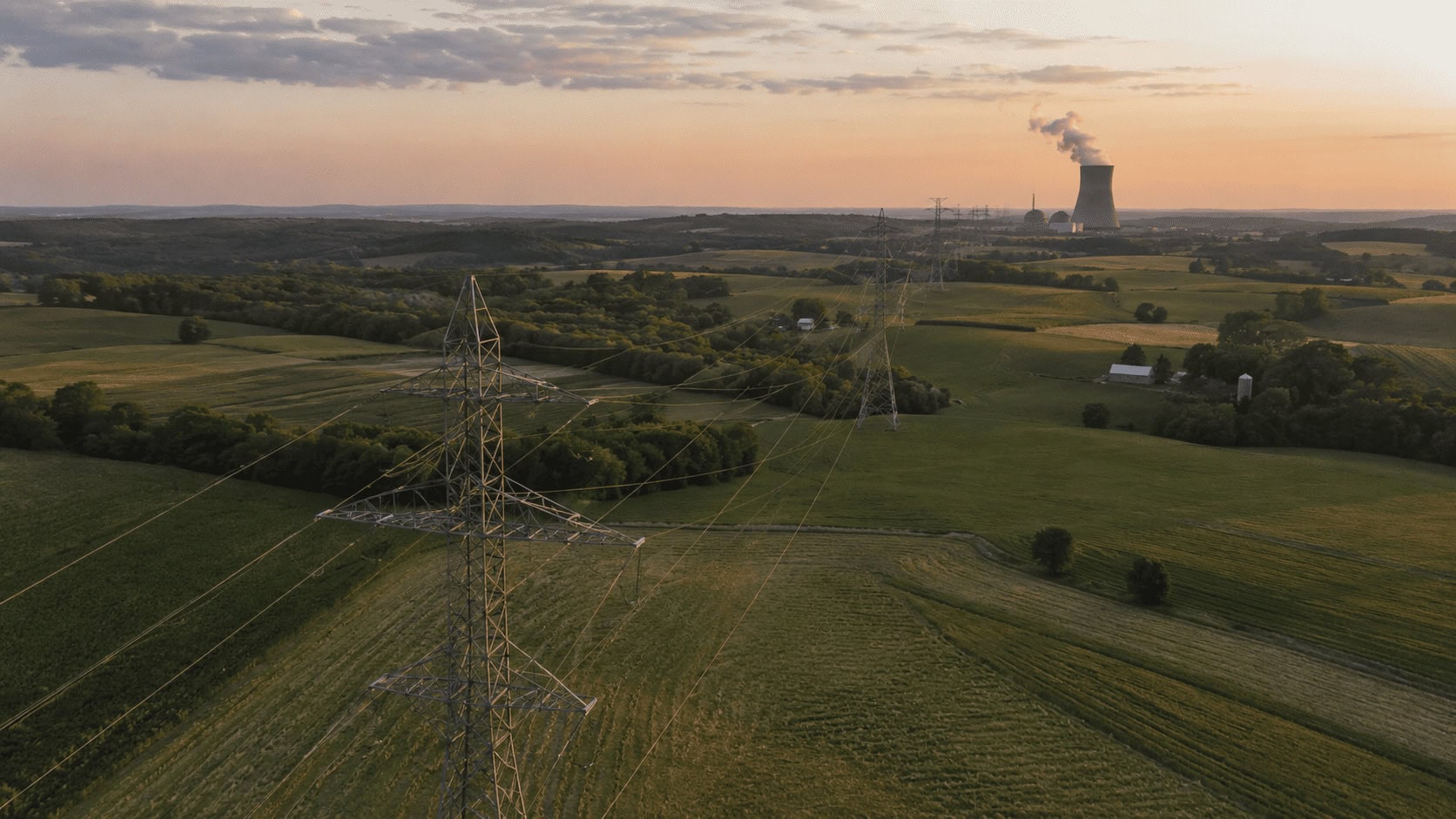 Pennsylvania farmland crossed by high-voltage transmission lines near a nuclear plant, the kind of land data center developers are paying $330,000 an acre for