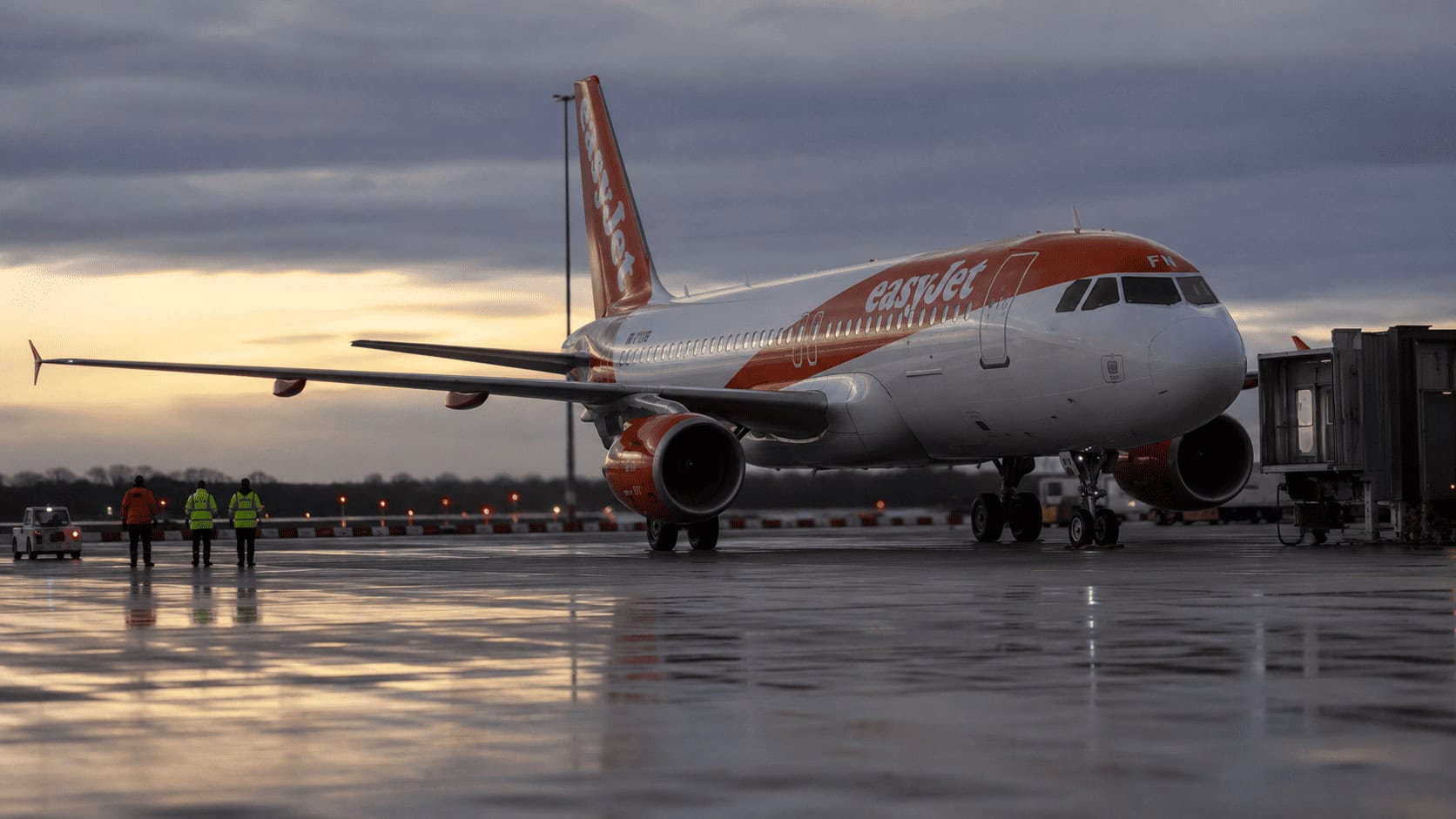 An easyJet aircraft parked on an airport apron at dusk as Apollo and Castlelake compete to take the airline private.