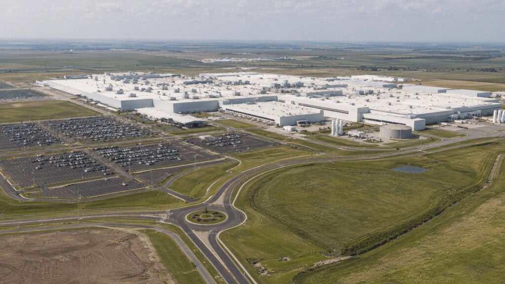 Aerial view of a large nicotine pouch manufacturing facility on open plains