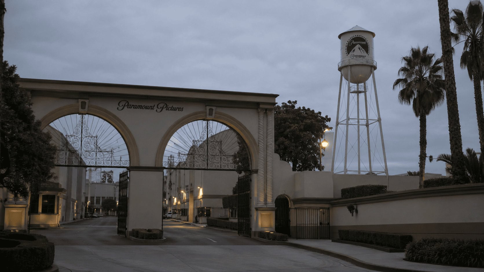 Paramount studio lot exterior at dusk, illustrating the debt pressure on the Warner Bros. Discovery deal.