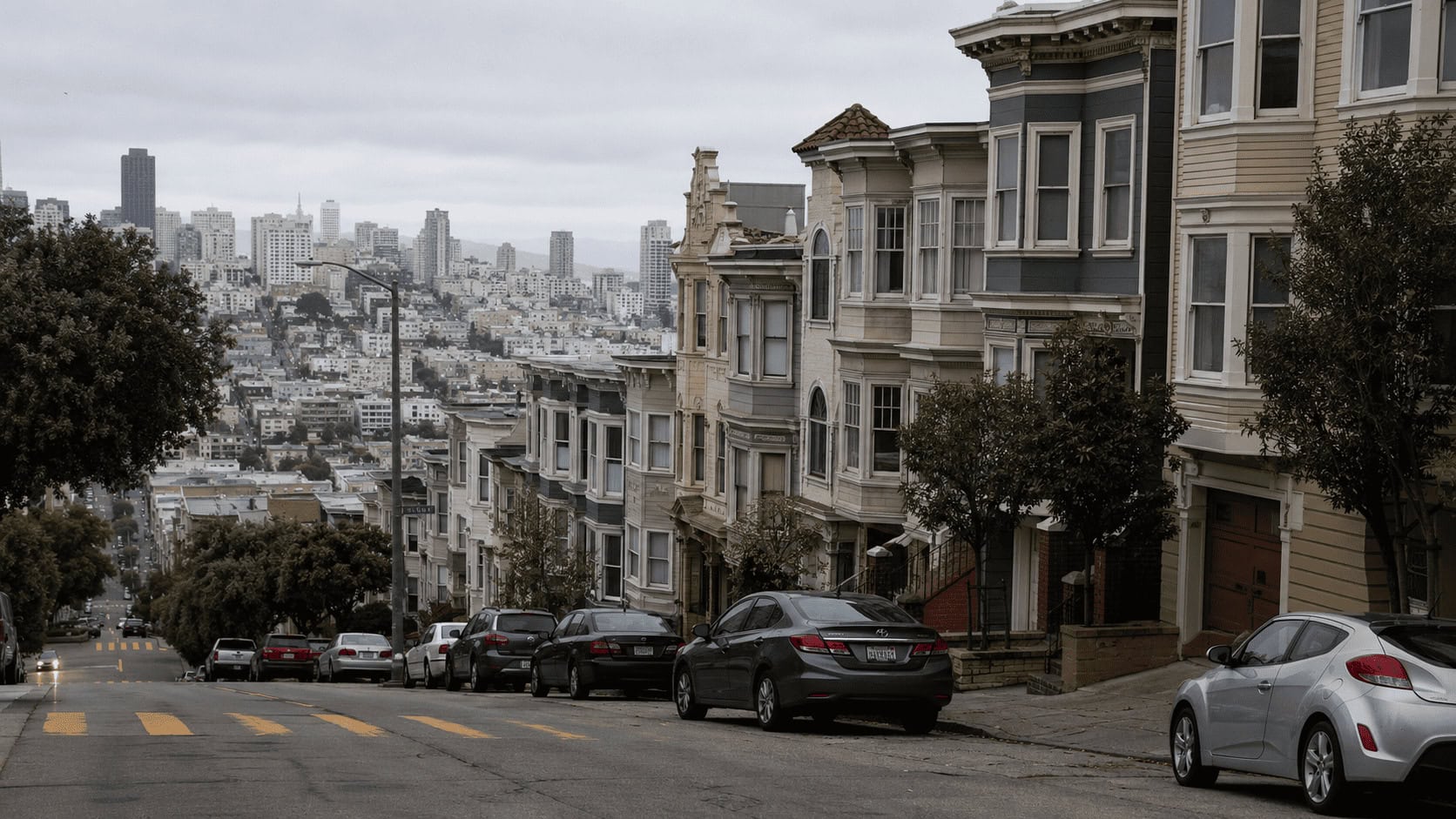 Row of San Francisco Victorian apartment buildings on a steep residential street, illustrating the city's housing crunch.