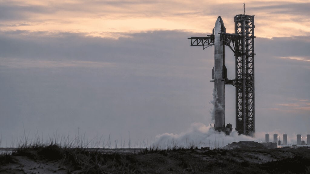 A Starship rocket on its launch mount at dusk ahead of a test flight, illustrating SpaceX's post-IPO catalyst