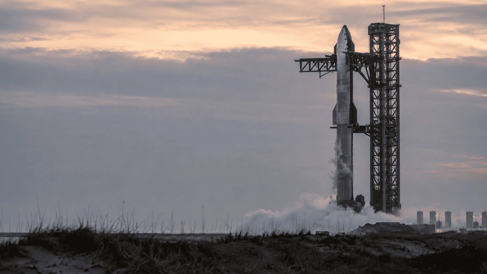 A Starship rocket on its launch mount at dusk ahead of a test flight, illustrating SpaceX's post-IPO catalyst