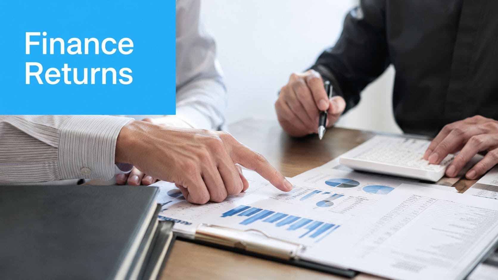 Two professionals in a business meeting analyzing financial charts and data on a desk together.