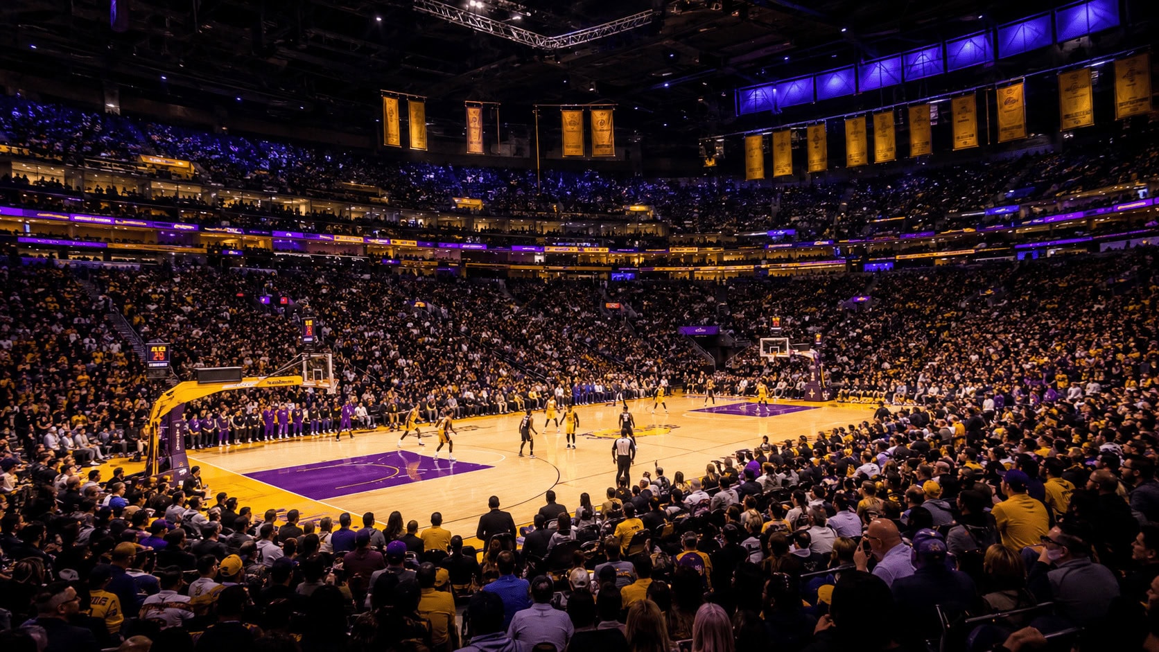 Crypto.com Arena in Los Angeles lit for a Lakers home game, purple and gold court visible from the upper bowl